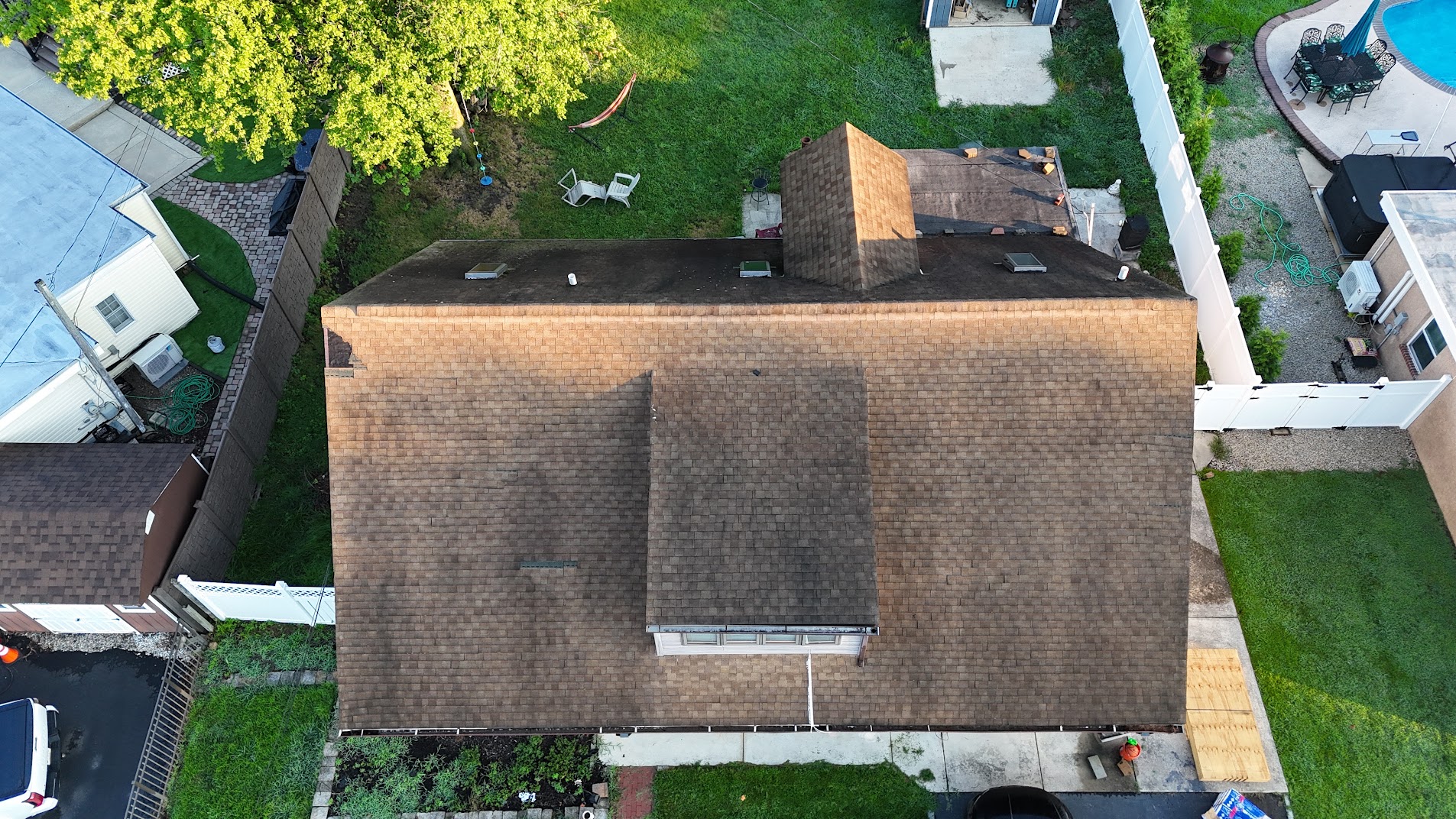 Aerial view of completed brown shingle roof