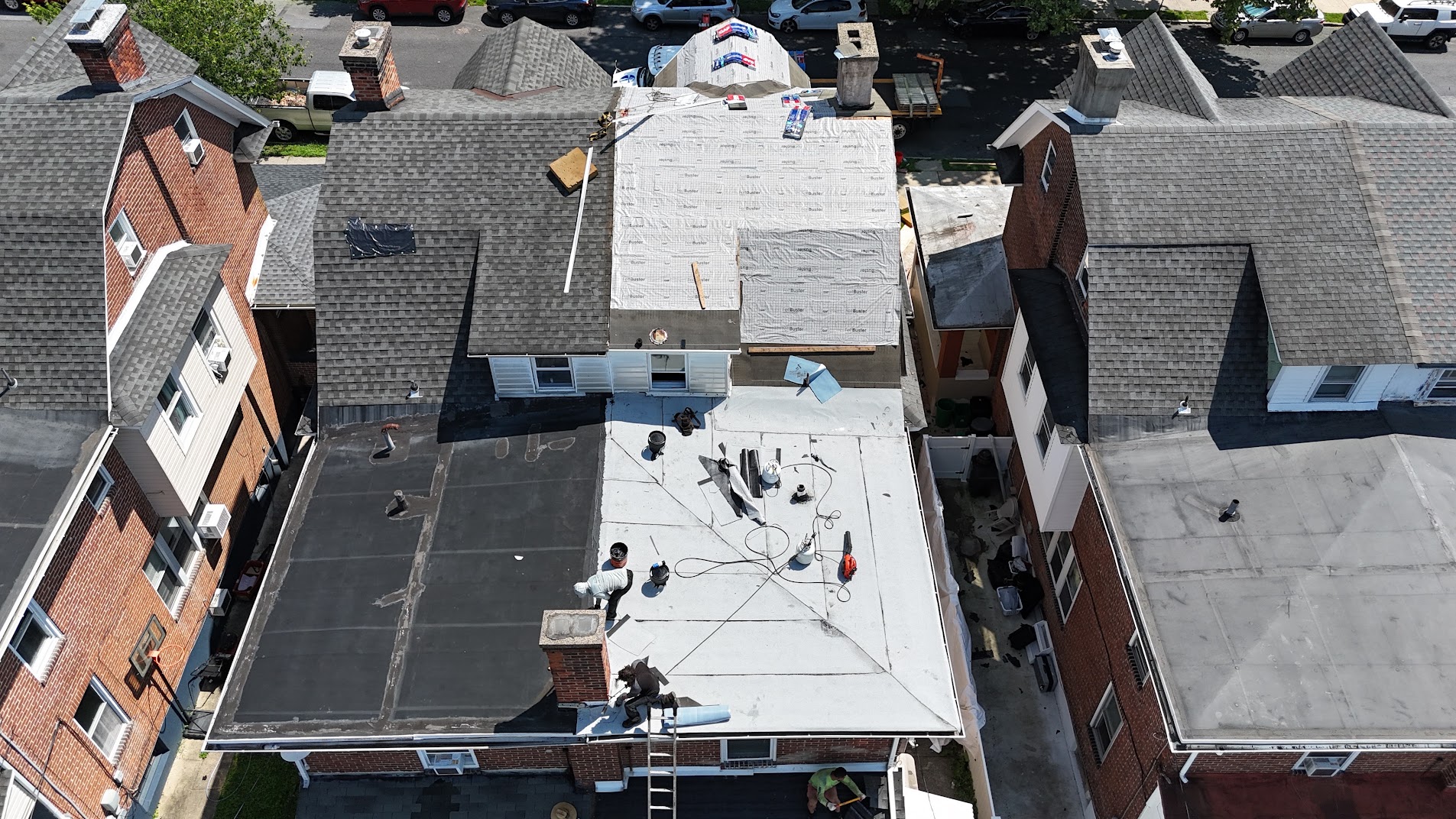 Crew installing underlayment on residential roof