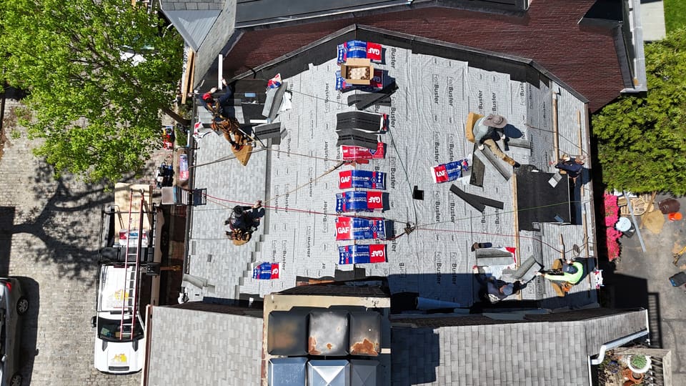 The same roof in underlayment with shingle bundles laid out