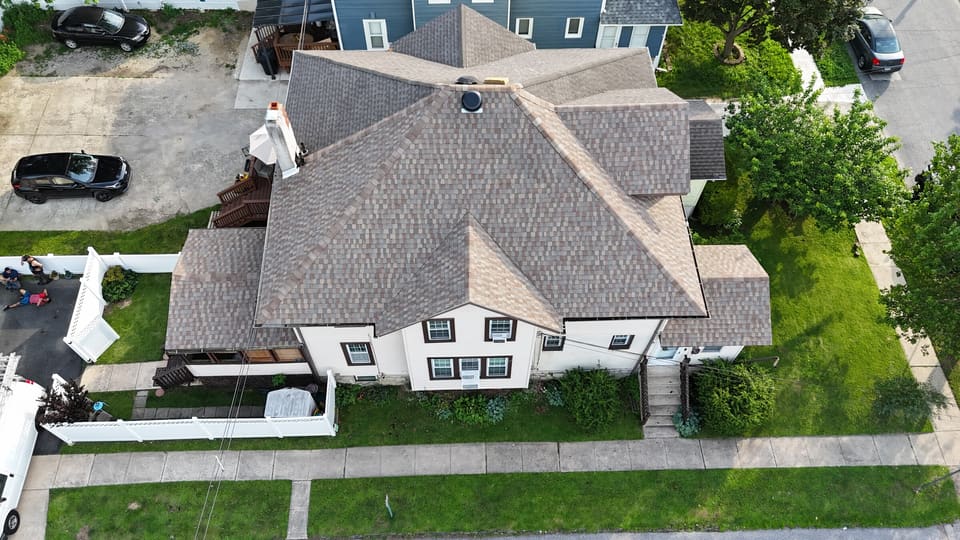 Drone view of the same house finished with new grey architectural shingles