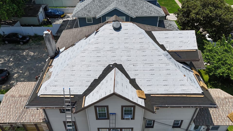 The same roof in white underlayment with new flashing going in