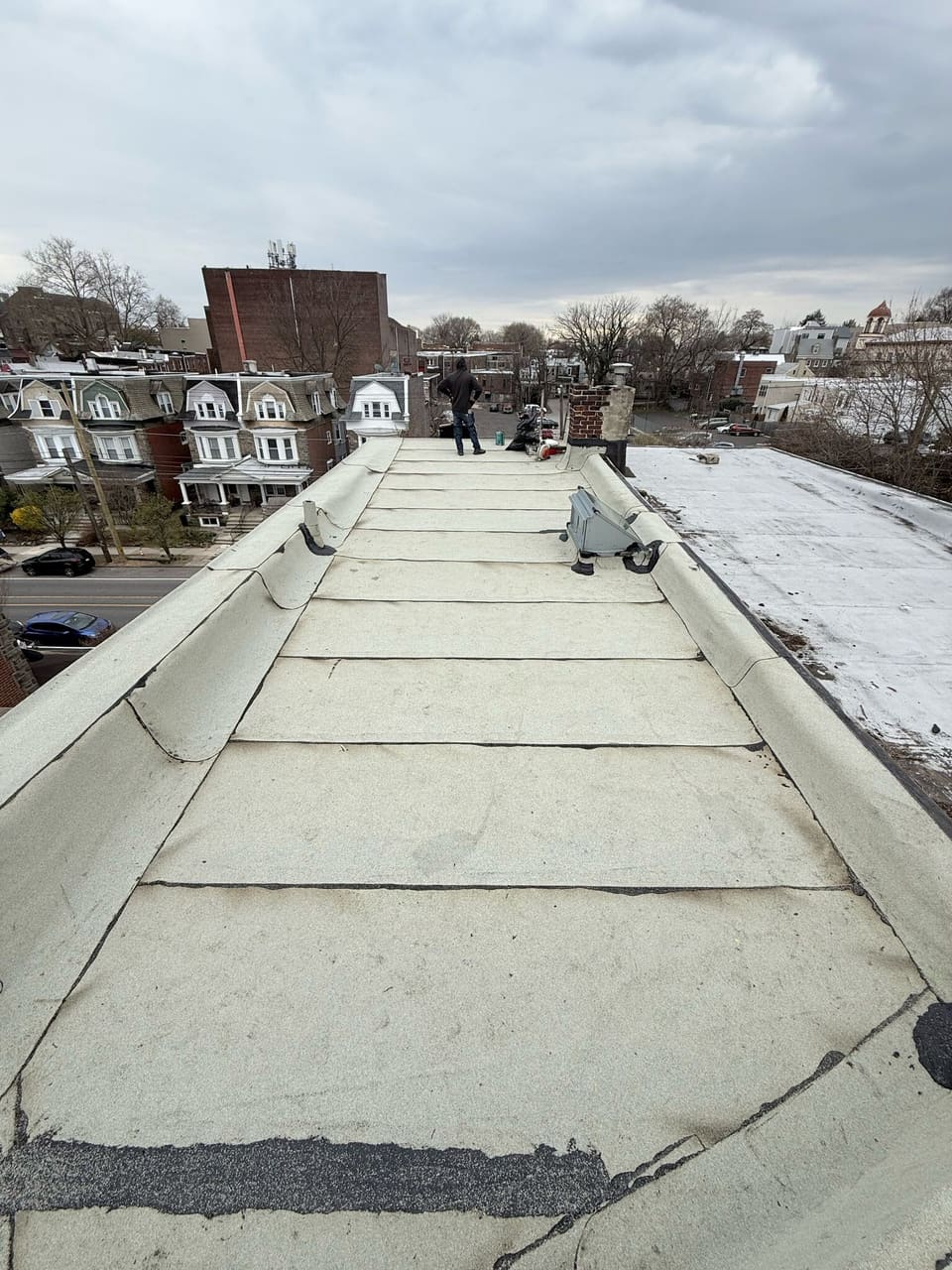 A finished white coated flat roof running along the row