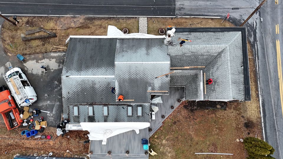 A large roof part way through, with work around the yard