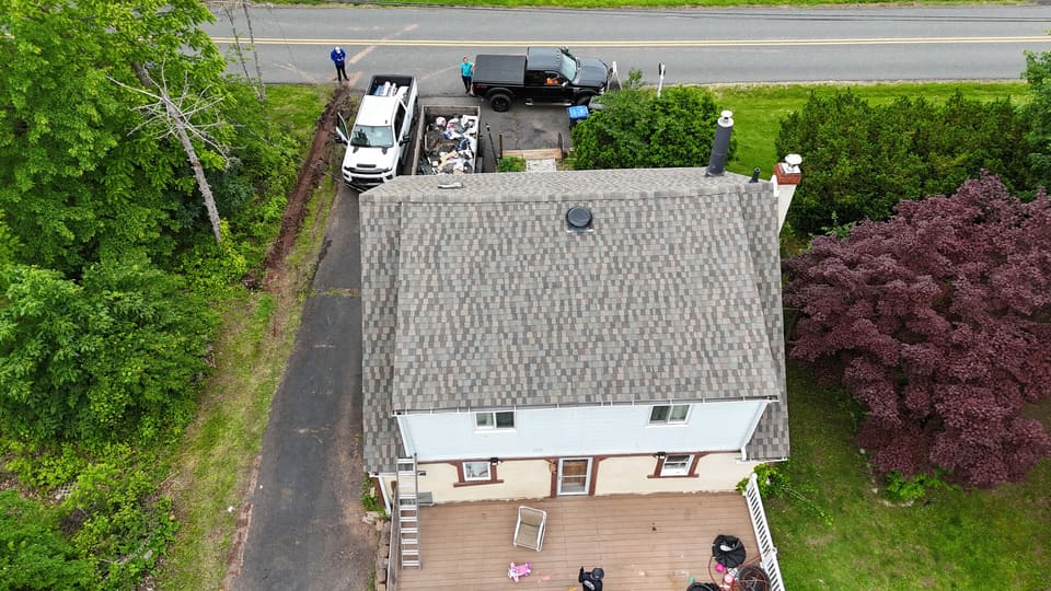 The finished grey shingle roof from the street side