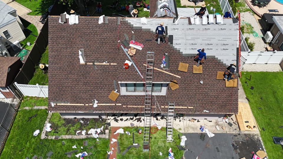 New shingles going on, ladders up the back of the house