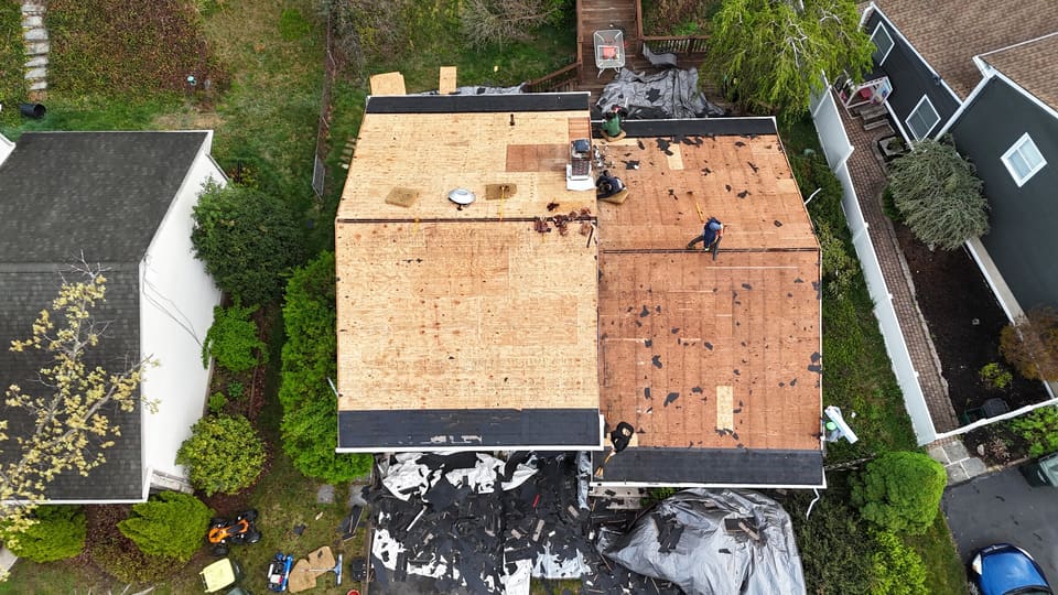 Drone view of a roof part way through, new decking on one side
