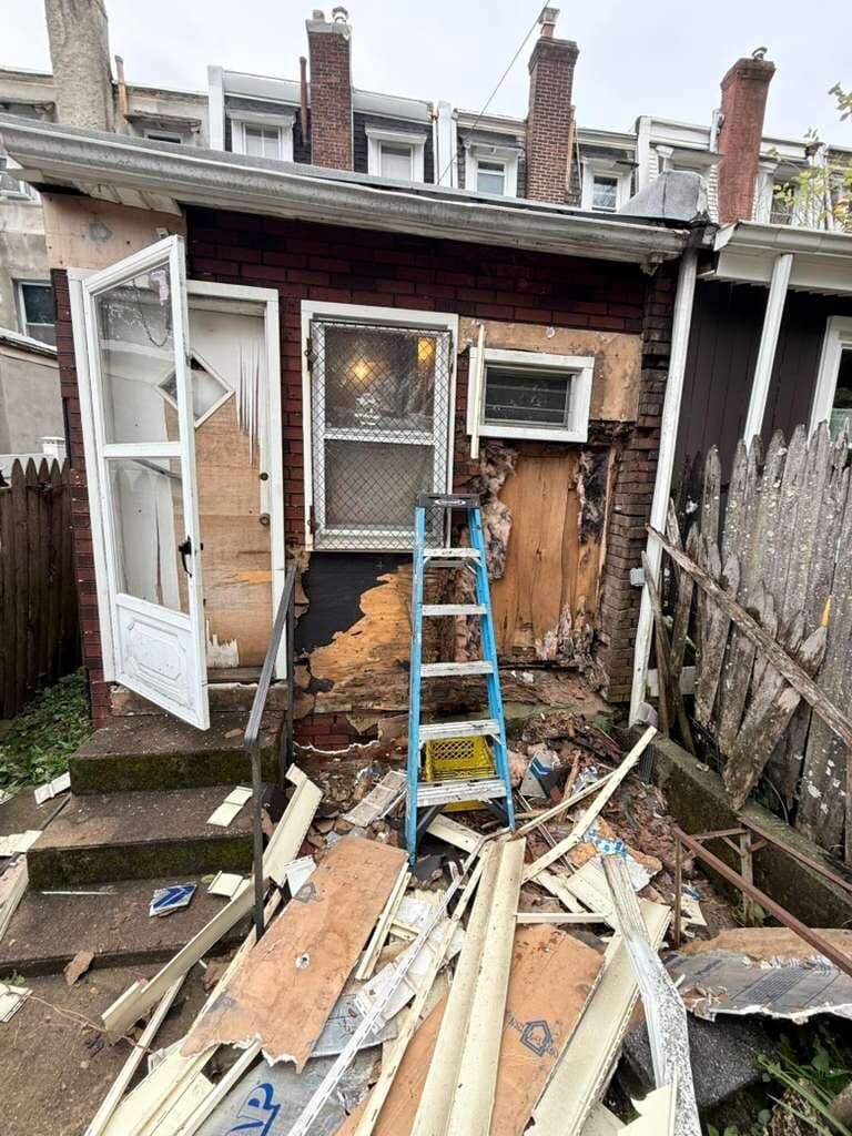 A row home rear opened up with the old siding torn off