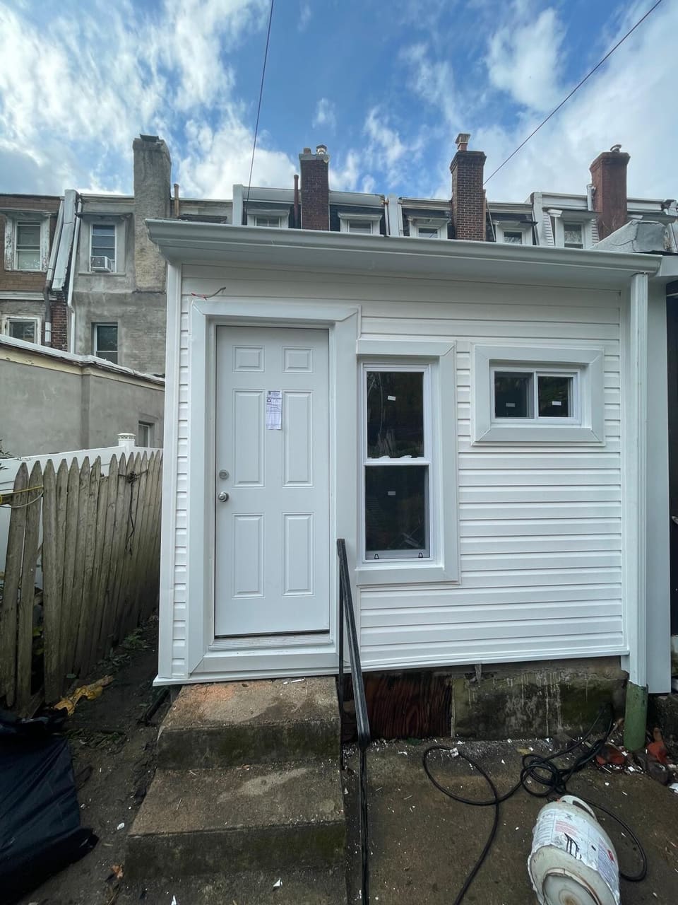 A rear addition finished in new white siding