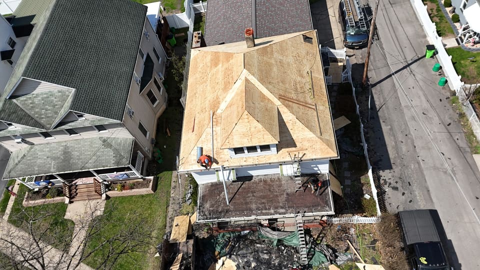 Bare wood decking across the roof during a reroof