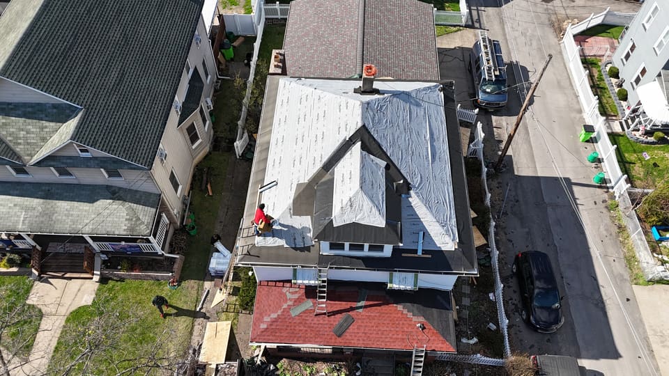 The roof in white underlayment with the crew at the ridge