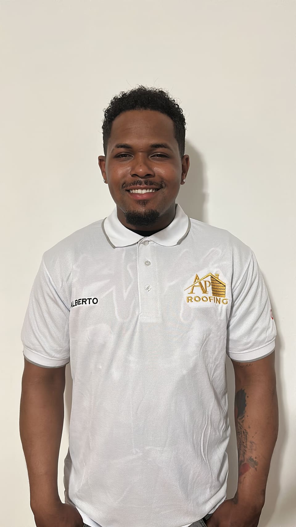 AP Roofing team member in a company polo
