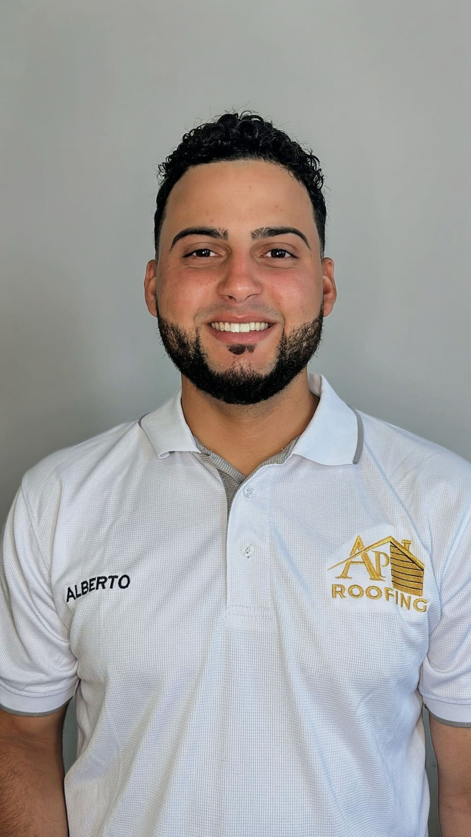 AP Roofing team member in a company polo