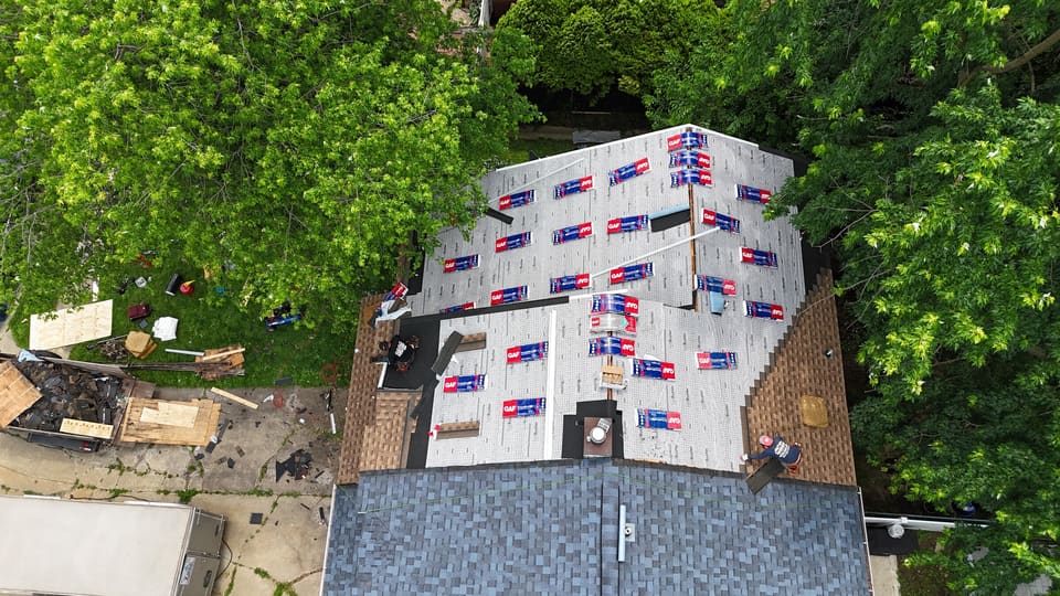 Underlayment and shingle bundles spread across a roof